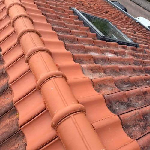 High-quality tiled roof with new skylight installation for improved natural light.